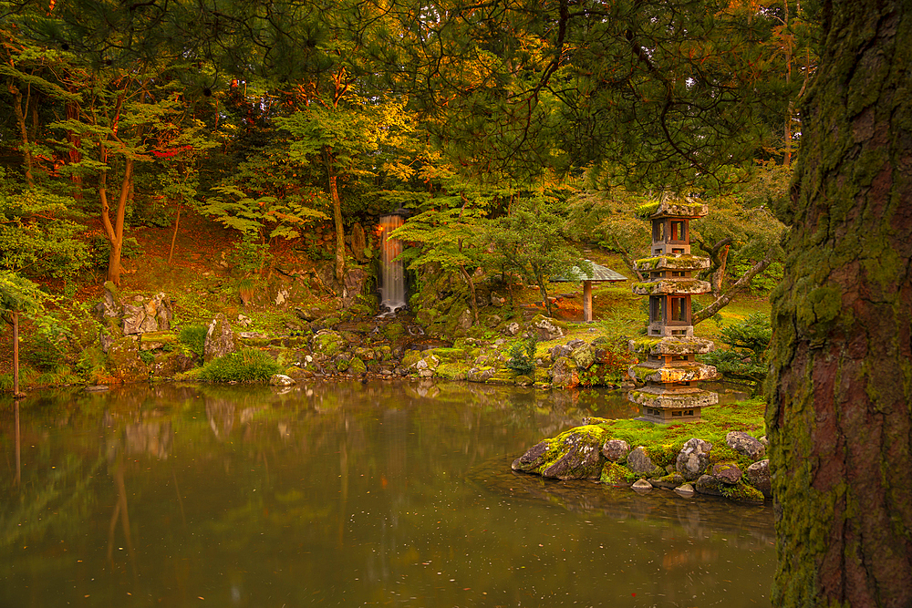 View of Hisago-ike Pond, Kaiseki Pagoda and waterfall in Kenrokumachi Japanese Garden, Kanazawa City, Ishikawa Prefecture, Honshu, Japan, Asia