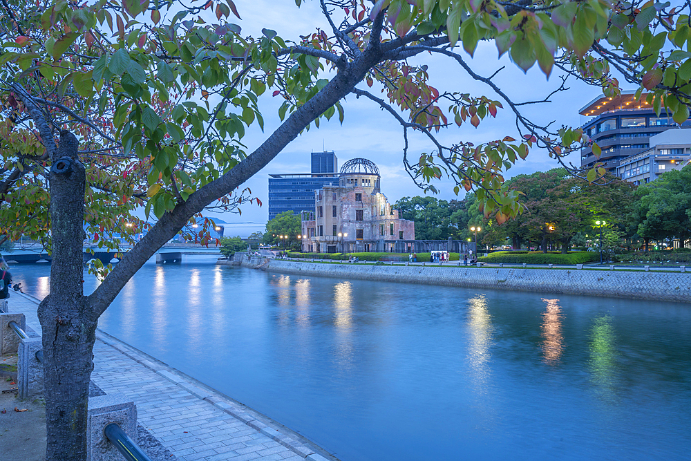 View of the skeletal ruins of the A-Bomb Dome from Hiroshima Peace Gardens at dusk, UNESCO, Hiroshima, Honshu, Japan