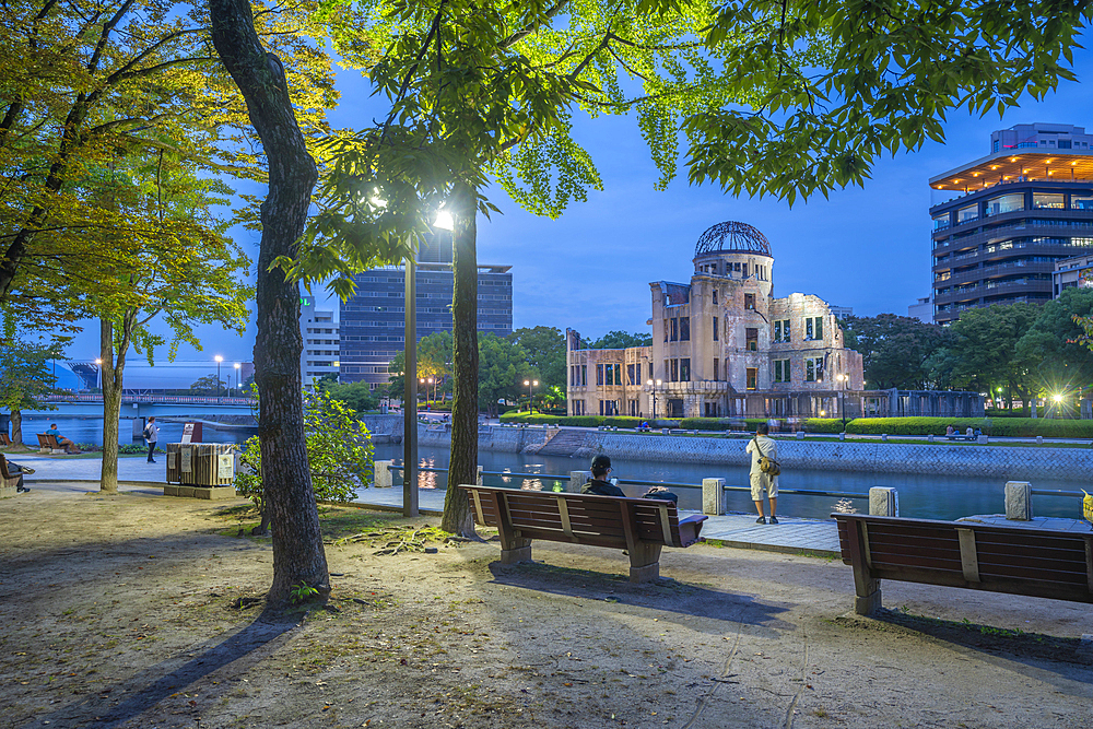 View of the skeletal ruins of the A-Bomb Dome from Hiroshima Peace Gardens at dusk, UNESCO World Heritage Site, Hiroshima, Honshu, Japan, Asia