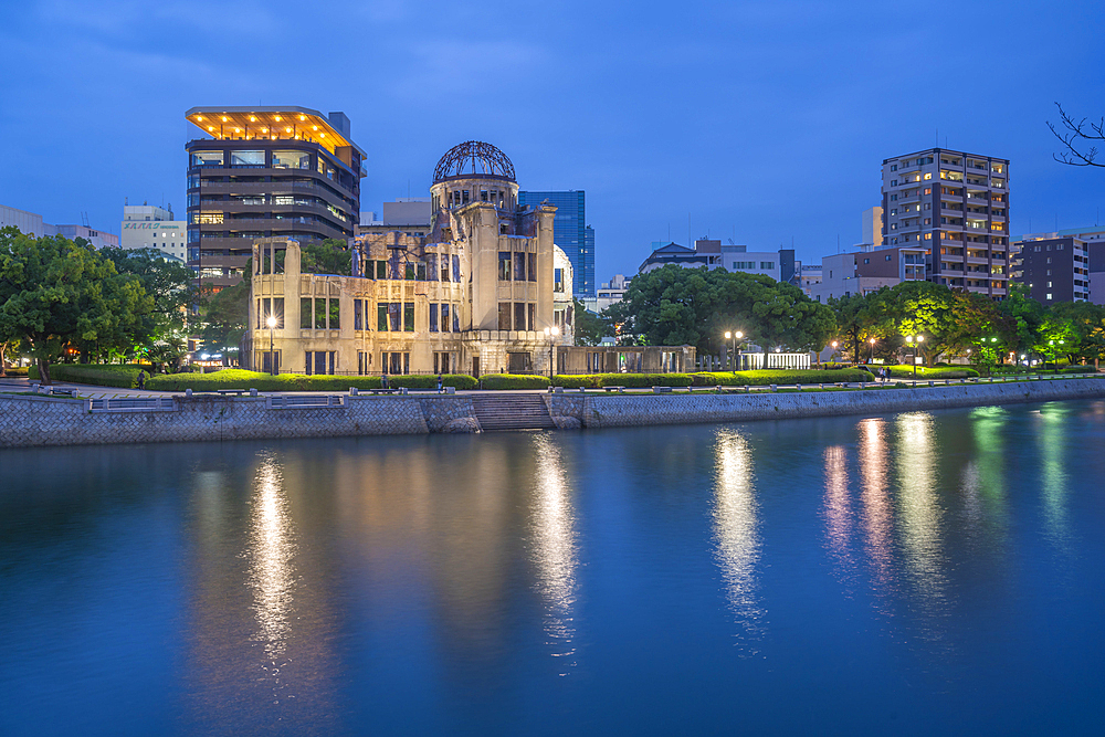 View of the skeletal ruins of the A-Bomb Dome from Hiroshima Peace Gardens at dusk, UNESCO World Heritage Site, Hiroshima, Honshu, Japan, Asia