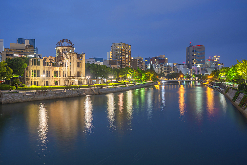 View of the skeletal ruins of the A-Bomb Dome from Hiroshima Peace Gardens at dusk, UNESCO, Hiroshima, Honshu, Japan