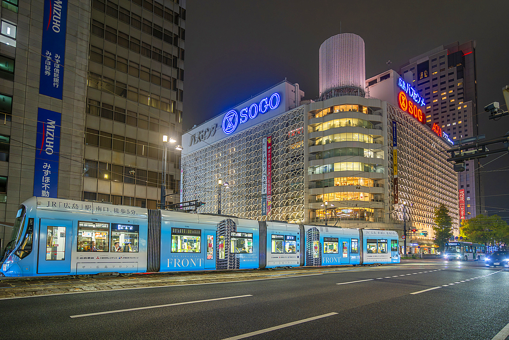 View of street scene, city tram and buildings in Hiroshima at night, Hiroshima, Honshu, Japan