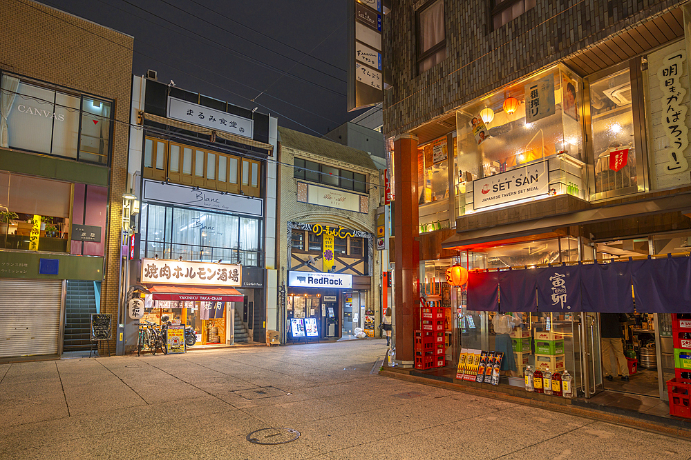 View of street scene and Japanese restaurants in Hiroshima at night, Hiroshima, Honshu, Japan