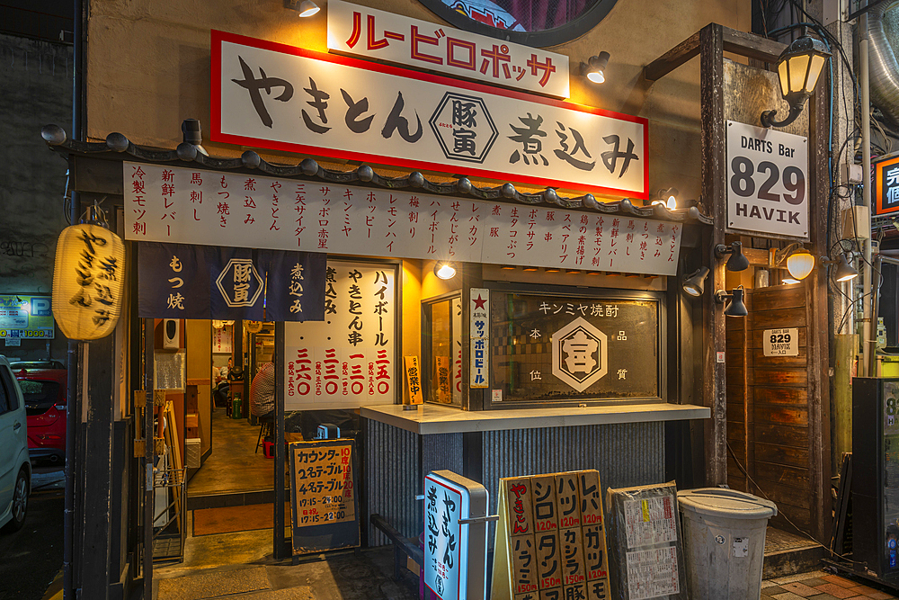 View of colourful Japanese restaurant entrance at night, Hiroshima, Honshu, Japan