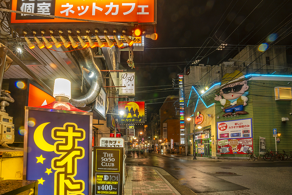 View of colourful restaurants and shops at night, Hiroshima, Honshu, Japan