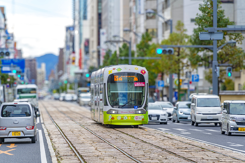 View of city tram on major street during daytime, Hondori, Naka Ward, Hiroshima, Honshu, Japan