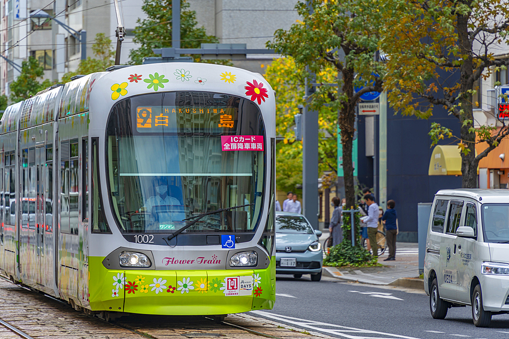 View of city tram on major street during daytime, Hondori, Naka Ward, Hiroshima, Honshu, Japan