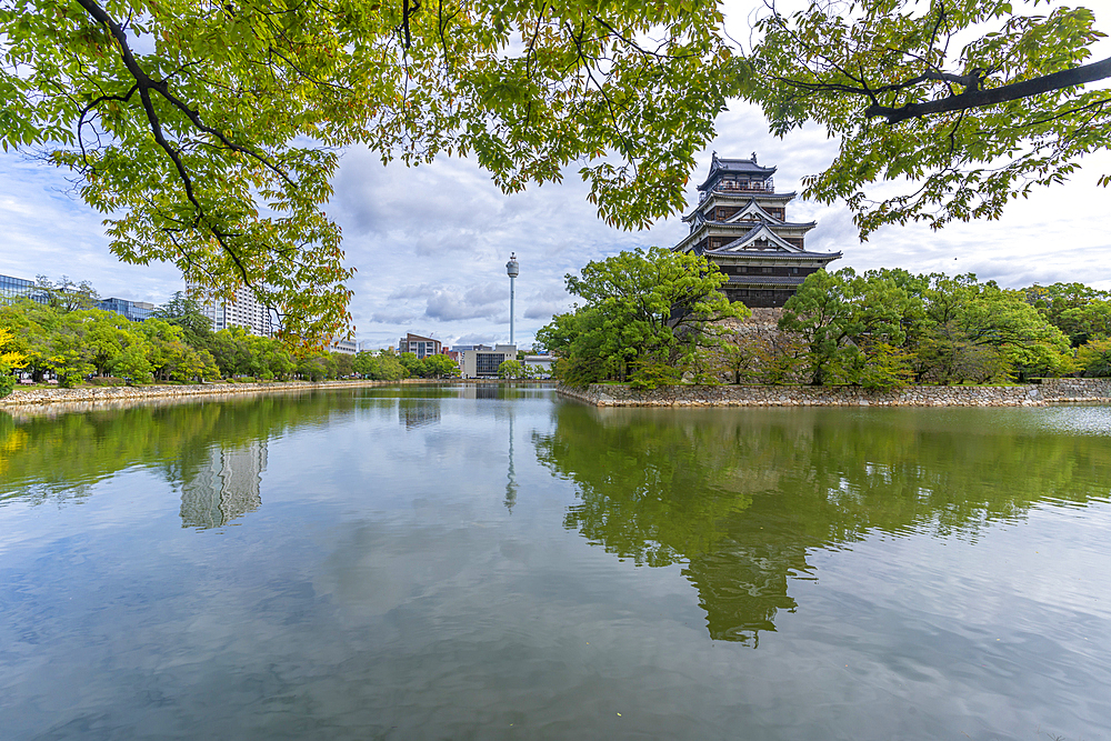 View of Hiroshima Castle, with museum, reflecting in Moat, Motomachi, Naka Ward, Hiroshima, Honshu, Japan