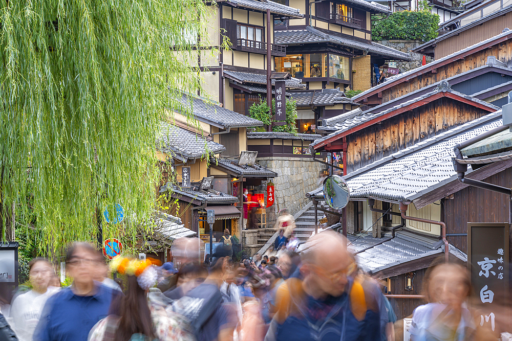 View of busy street and traditional wooden houses in Gion, Kyoto Geisha District, Kyoto, Honshu, Japan