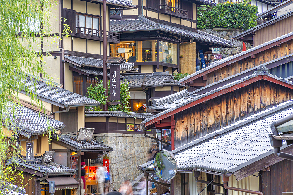 View of busy street and traditional wooden houses in Gion, Kyoto Geisha District, Kyoto, Honshu, Japan