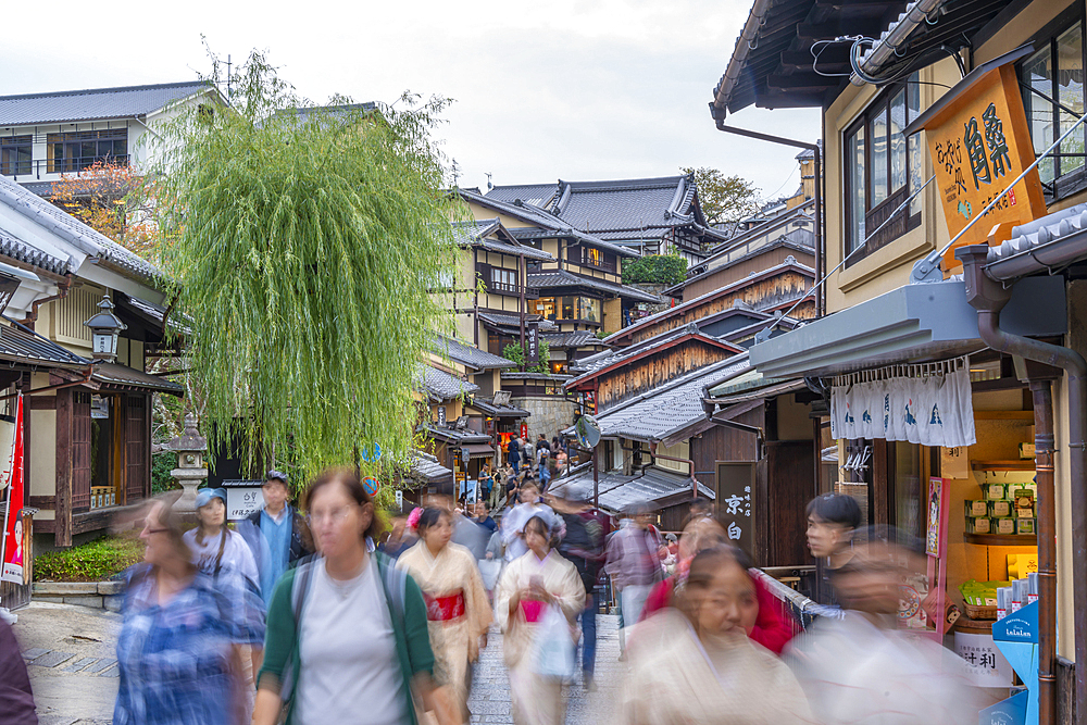 View of busy street and traditional wooden houses in Gion, Kyoto Geisha District, Kyoto, Honshu, Japan