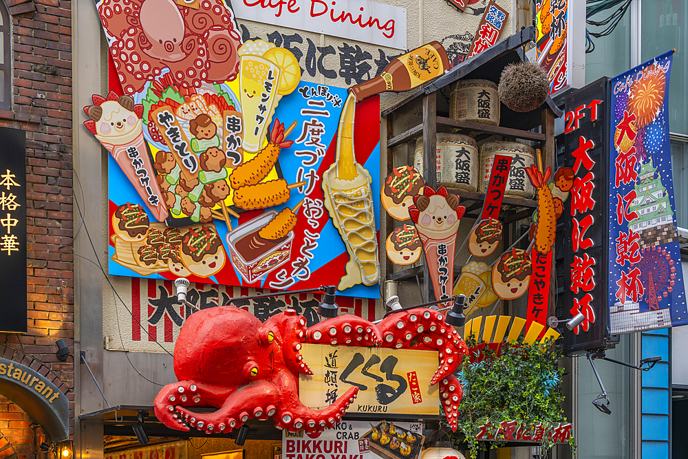 View of colourful facades of restaurants in Dotonbori, vibrant entertainment district near the river, Osaka, Honshu, Japan