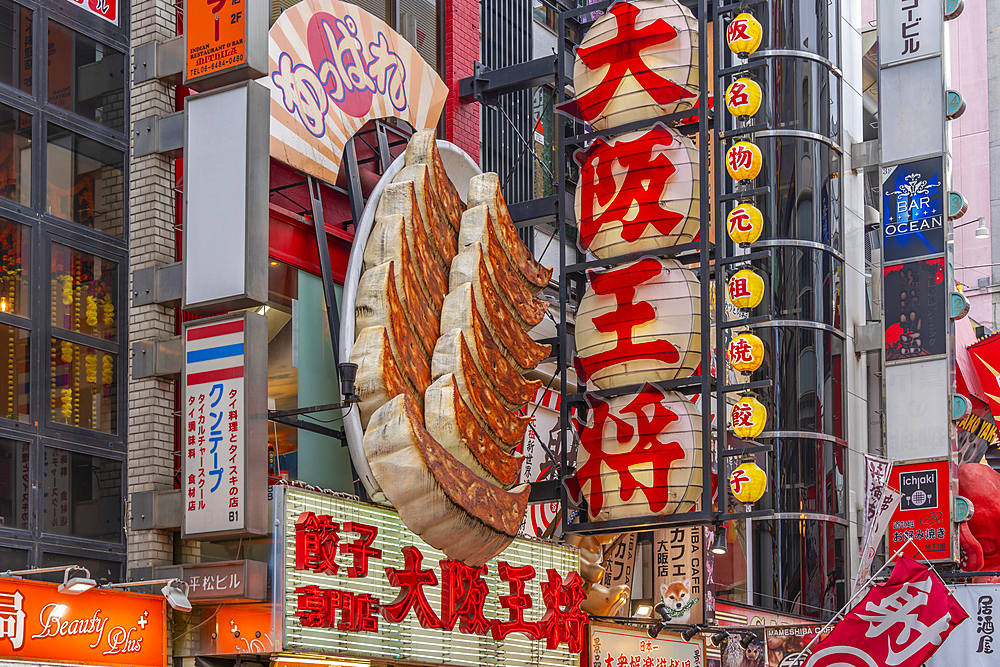 View of colourful facades of restaurants in Dotonbori, vibrant entertainment district near the river, Osaka, Honshu, Japan