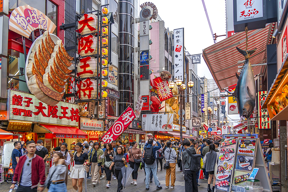 View of colourful signs of restaurants in Dotonbori, vibrant entertainment district near the river, Osaka, Honshu, Japan