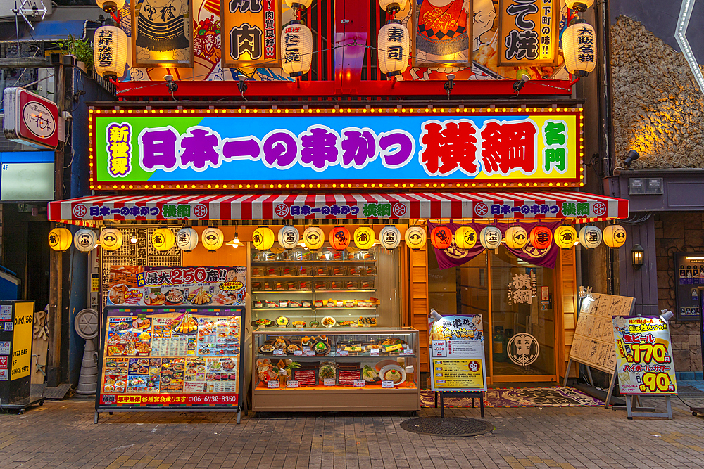 View of colourful facade of shop in Dotonbori, vibrant entertainment district near the river, Osaka, Honshu, Japan, Asia