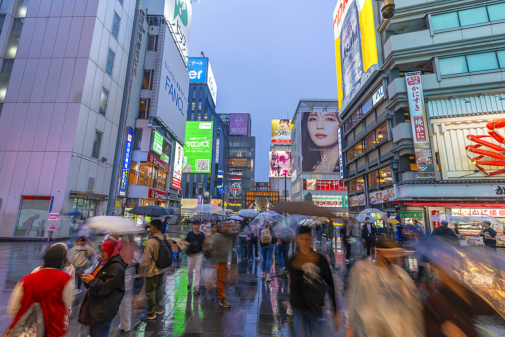 View of colourful adverts in Dotonbori, vibrant entertainment district near the river at dusk, Osaka, Honshu, Japan