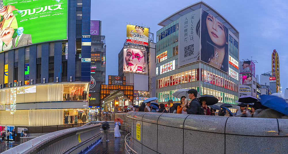 View of colourful adverts in Dotonbori, vibrant entertainment district near the river at dusk, Osaka, Honshu, Japan