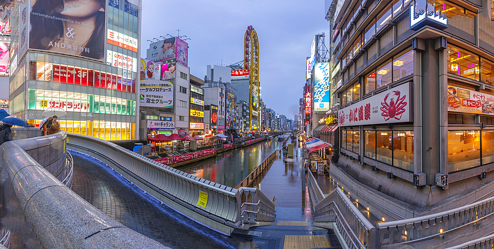 View of colourful adverts in Dotonbori, vibrant entertainment district near the river at dusk, Osaka, Honshu, Japan