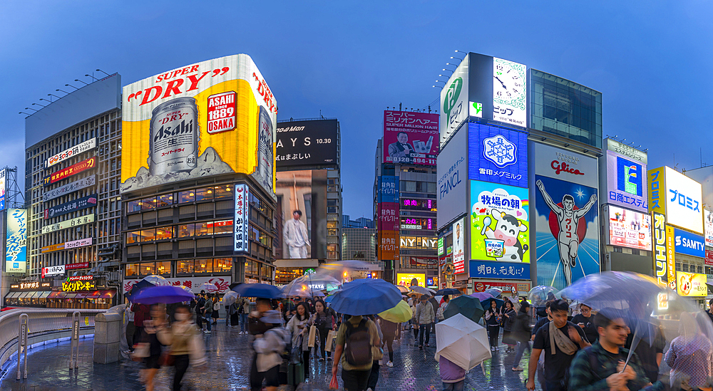 View of Glico sign of Dotonbori, vibrant entertainment district near the river at dusk, Osaka, Honshu, Japan, Asia