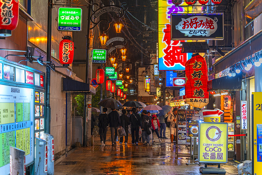 View of colourful signs in backstreet in Dotonbori, vibrant entertainment district near the river, Osaka, Honshu, Japan