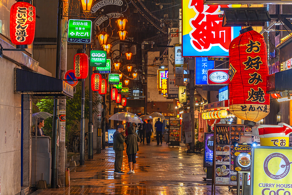 View of colourful signs in backstreet in Dotonbori, vibrant entertainment district near the river, Osaka, Honshu, Japan