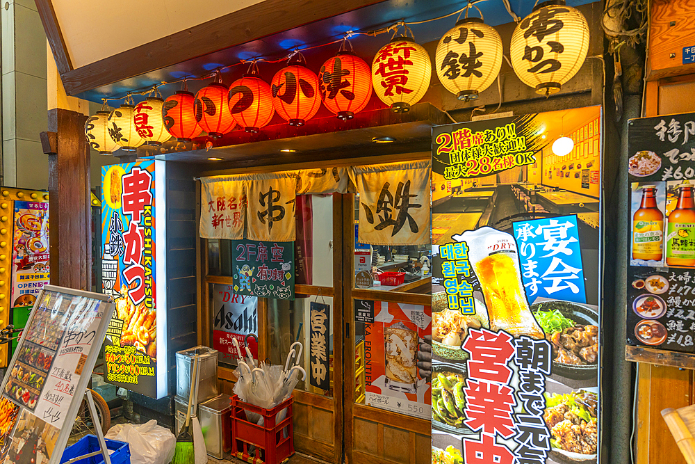 View of colourful signs in backstreet in Dotonbori, vibrant entertainment district near the river, Osaka, Honshu, Japan