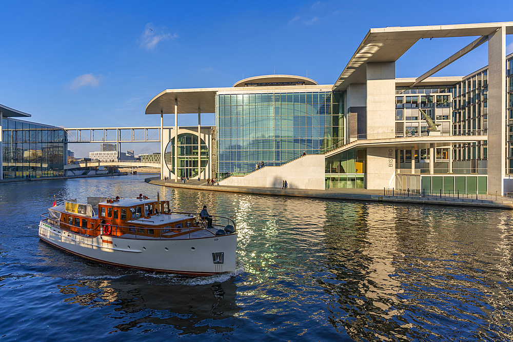 View of sightseeing cruise boat on River Spree and the Marie-Elisabeth-Luders-Haus, Mitte, Berlin, Germany, Europe