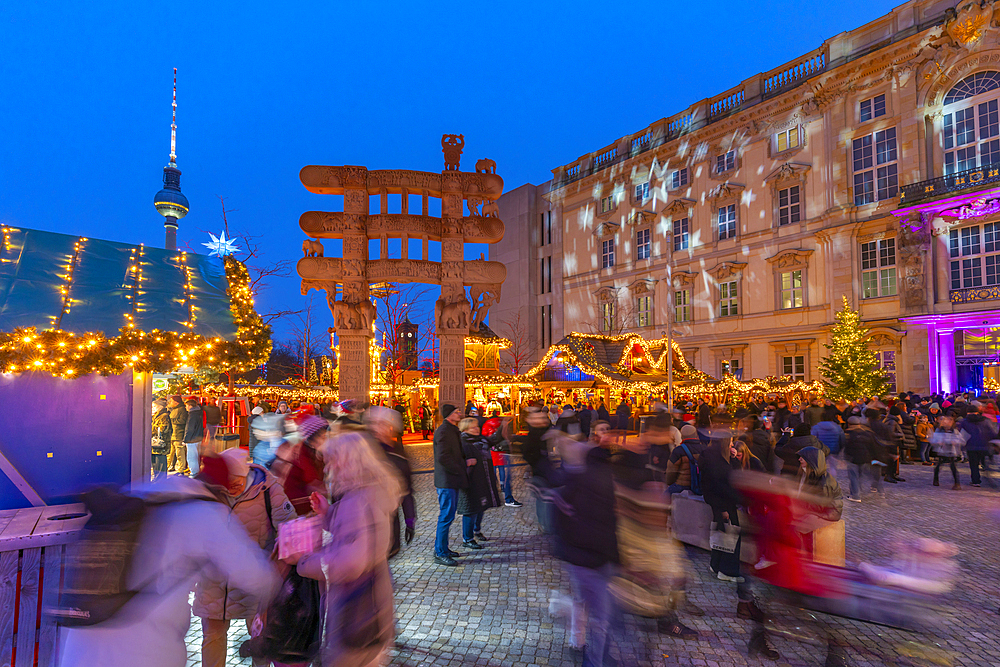 View of Christmas market stalls in Vorplatz Berliner Schloss at Christmas and Berlin TV Tower in background, Mitte, Berlin, Germany, Europe