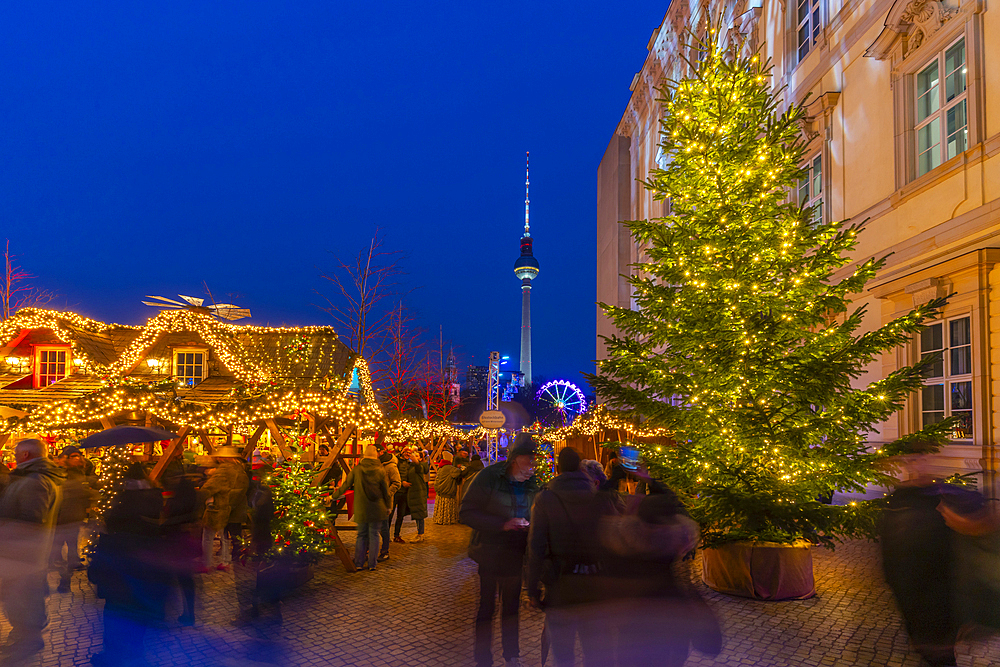 View of Christmas market stalls in Vorplatz Berliner Schloss at Christmas and Berlin TV Tower in background, Mitte, Berlin, Germany, Europe