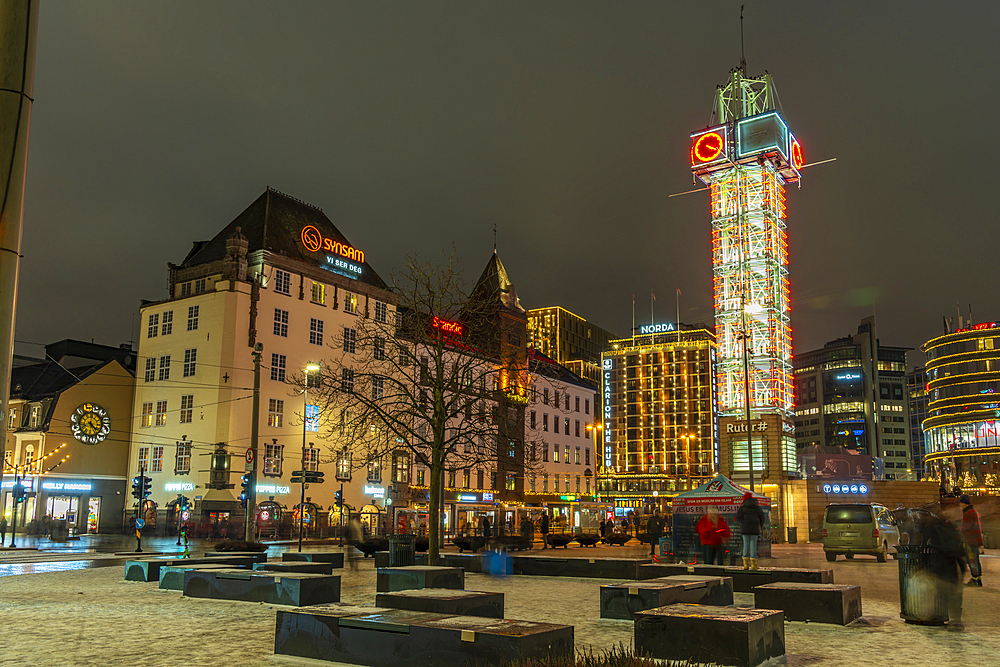 View of buildings and city tram in Jernbanetorget during winter at dusk, Oslo, Norway, Scandinavia, Europe