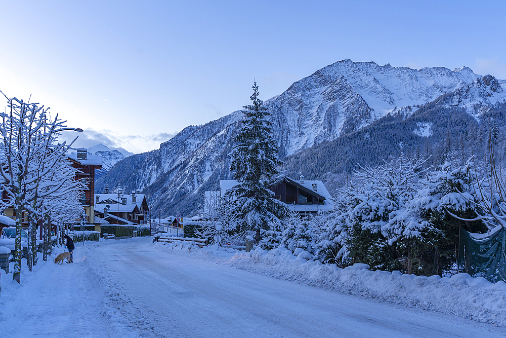 View of chalets and snow covered mountains in Courmayeur before dawn during winter, Courmayeur, Aosta Valley, Italy, Europe