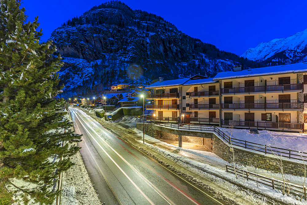 View of chalets and snow covered mountains in Courmayeur at dusk during winter, Courmayeur, Aosta Valley, Italy, Europe