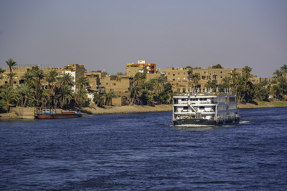 View of scenery and cruise boat from cruise boat near Armant on the Nile River, Luxor, Egypt, Africa
