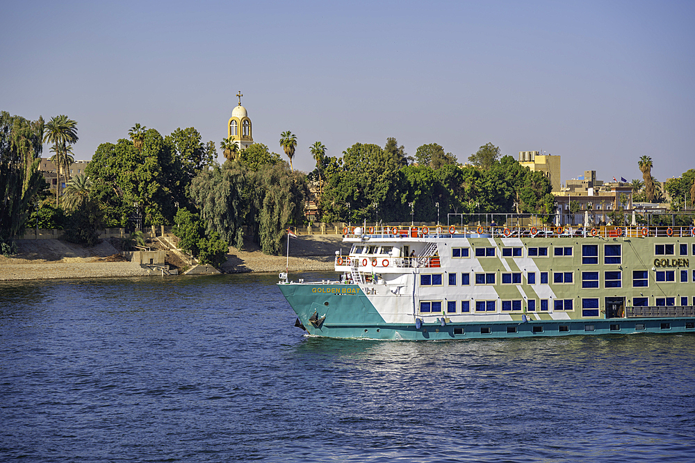 View of scenery and cruise boat from cruise boat near Armant on the Nile River, Luxor, Egypt, Africa