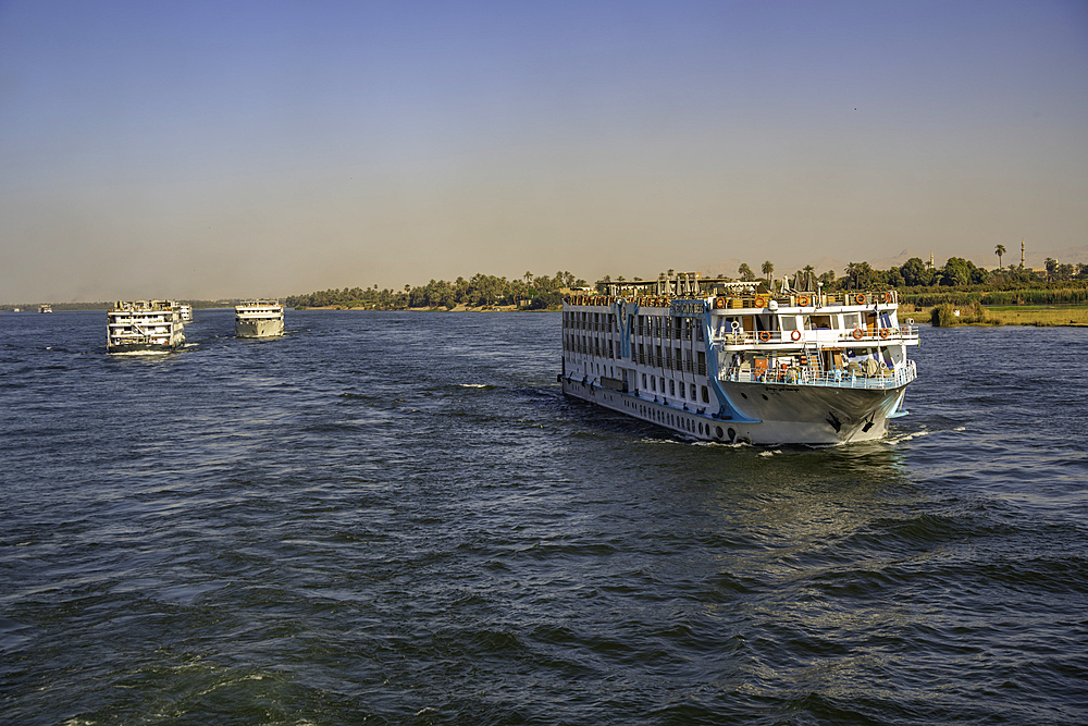 View of scenery and cruise boat from cruise boat near Armant on the Nile River, Luxor, Egypt, Africa