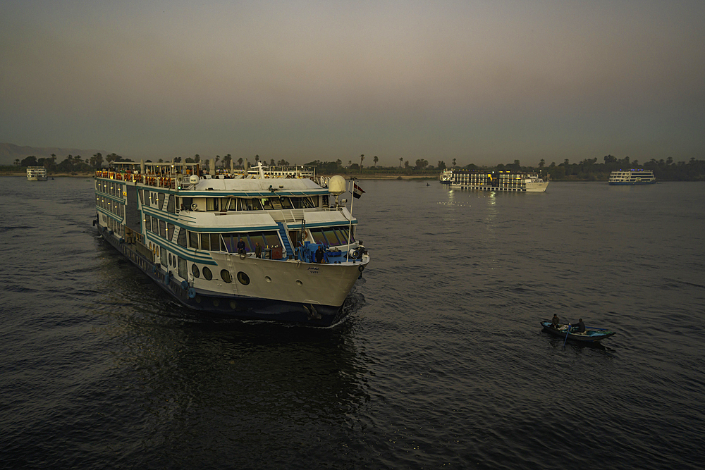 View of cruise boats from cruise boat near Esna on the Nile River at sunset, Esna, Egypt, Africa