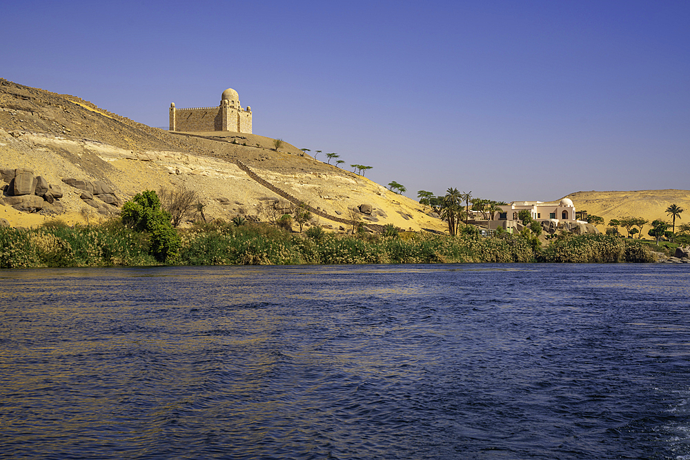 View of the Nile river and Aga Khan Mausoleum from small boat in Aswan, Aswan, Nubia, Egypt, North Africa, Africa