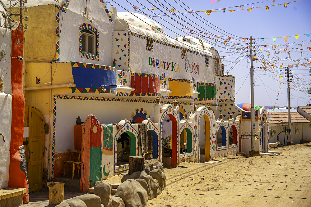 View of colourful architecture at Nagaa Suhayl Gharb on the Nile river near Aswan, Aswan, Nubia, Egypt, North Africa, Africa