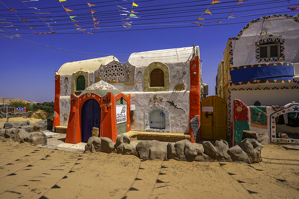 View of colourful architecture at Nagaa Suhayl Gharb on the Nile river near Aswan, Aswan, Nubia, Egypt, North Africa, Africa