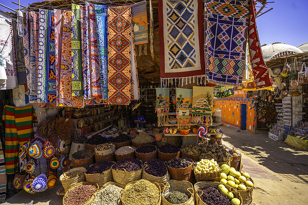 View of colourful market stalls at Nagaa Suhayl Gharb on the Nile river near Aswan, Aswan, Nubia, Egypt, North Africa, Africa