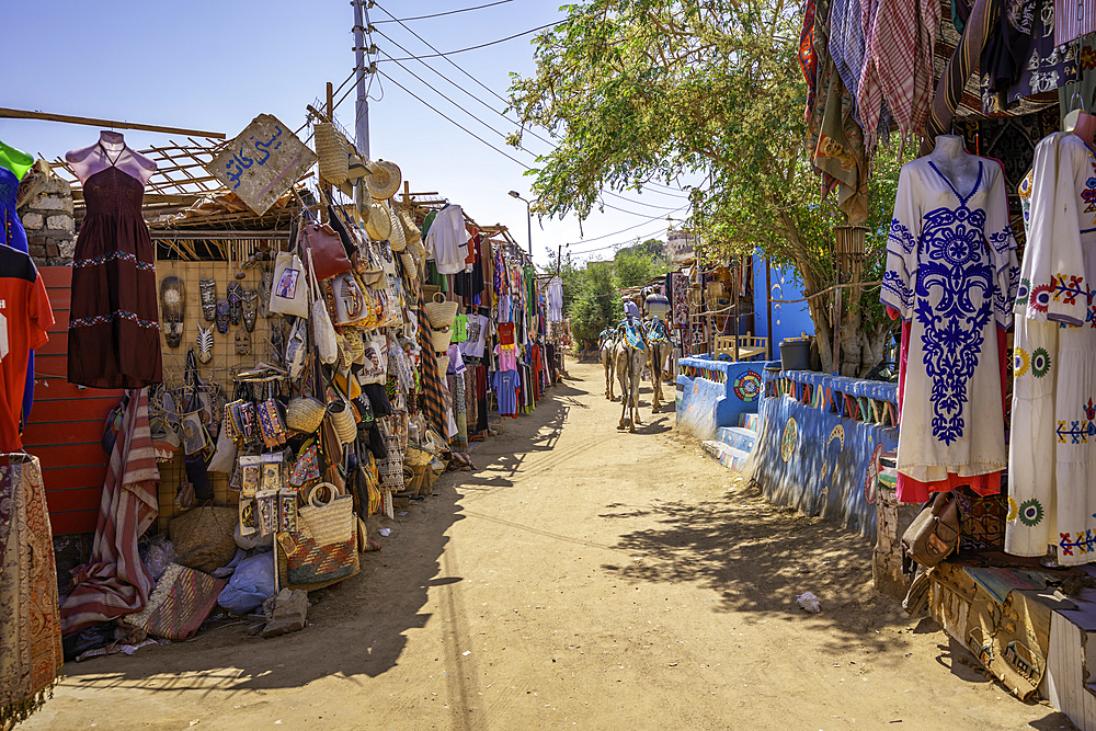 View of colourful market stalls at Nagaa Suhayl Gharb on the Nile river near Aswan, Aswan, Nubia, Egypt, North Africa, Africa