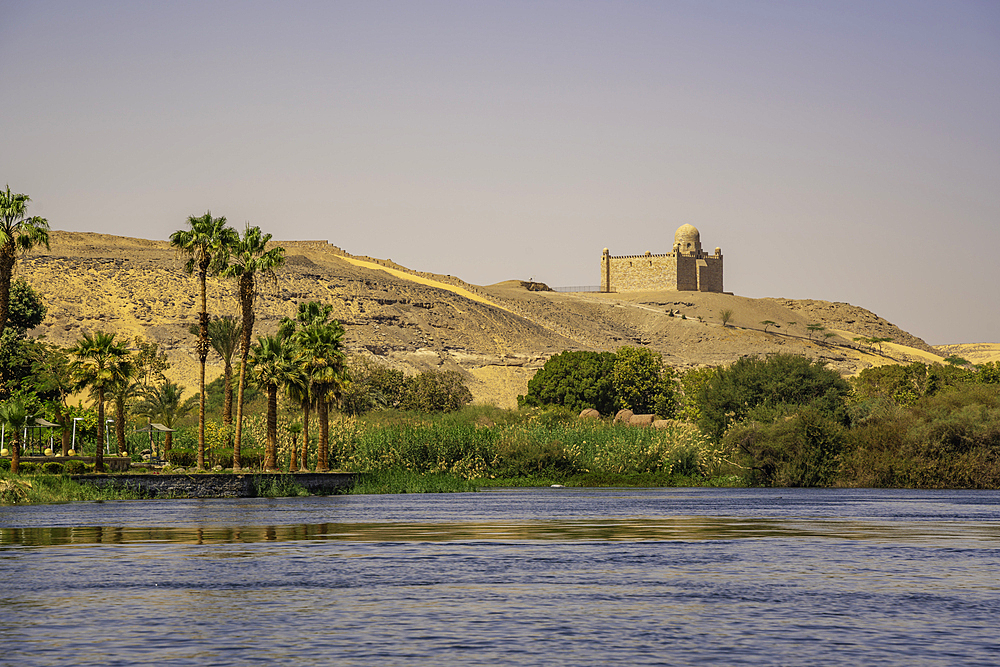 View of the Nile river and Aga Khan Mausoleum from small boat in Aswan, Aswan, Nubia, Egypt, North Africa, Africa