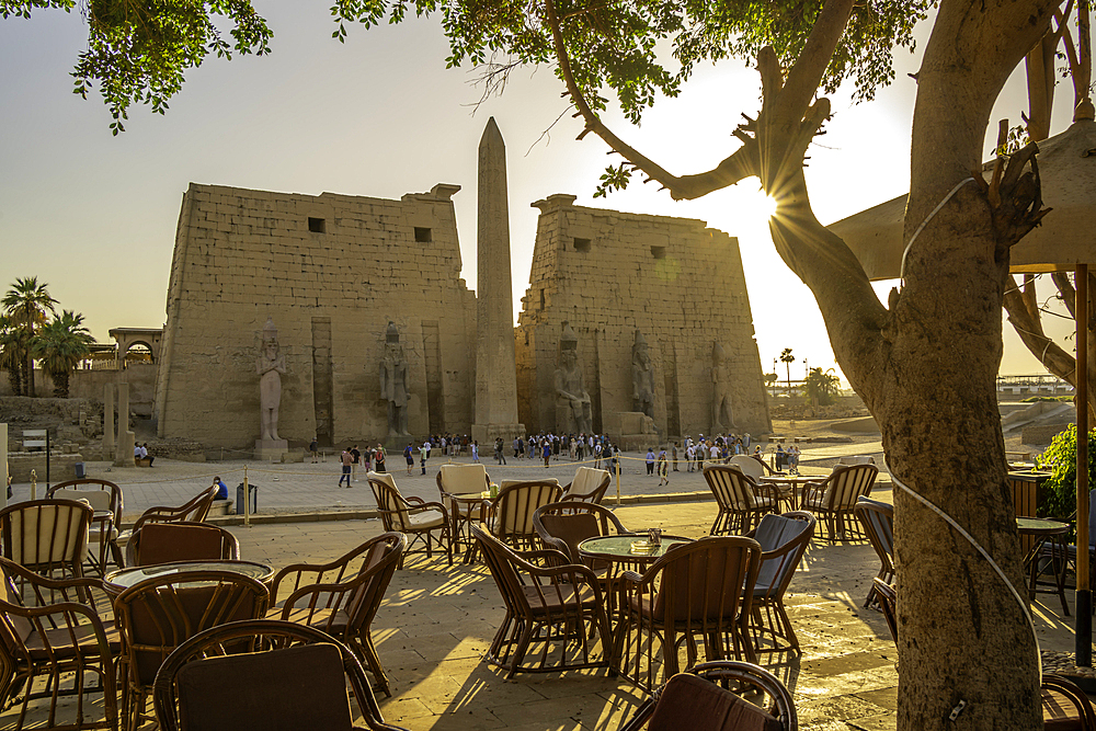 View of Luxor Temple and cafe during golden hour, Luxor, Egypt, Africa