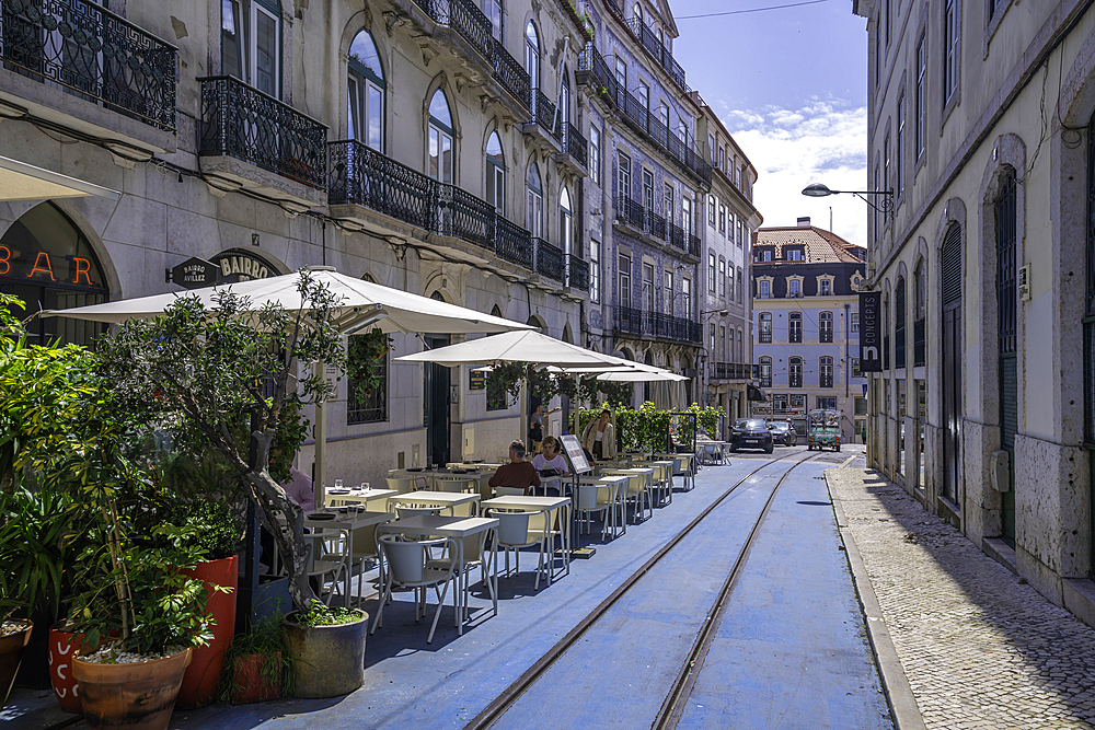 View of cafe and old tram lines in Lisbon city centre, Lisbon, Portugal, Europe