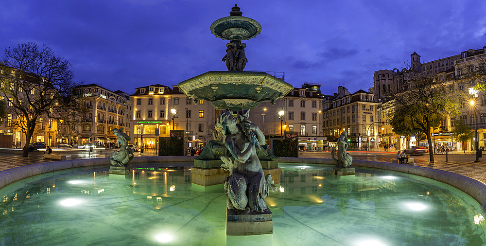 View of South fountain of Rossio in Praca do Rossio at dusk, Lisbon, Portugal, Europe