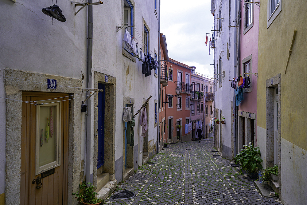 View of narrow cobbled street close to Lisbon Castle, Alfama District, Lisbon, Portugal, Europe