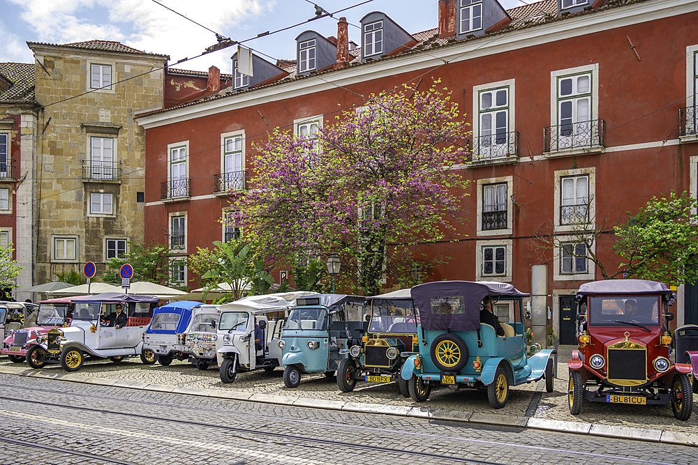 View of Tuk Tuks and colourful architecture in Alfama, Alfama District, Lisbon, Portugal, Europe