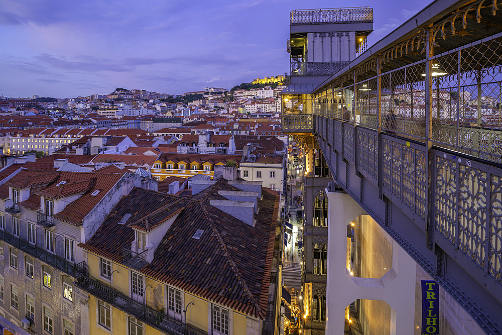 View of city rooftops and Santa Justa Lift from Carmo Archaeological Museum at dusk, Lisbon, Portugal, Europe