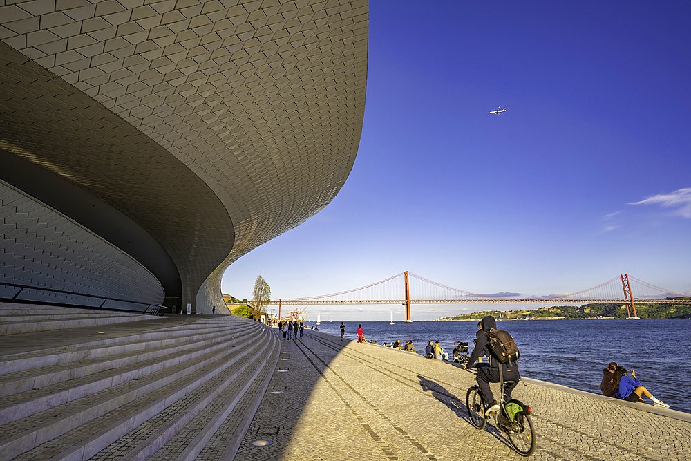 View of MAAT - Museum of Art, Architecture and Technology and 25 April Bridge on a sunny day, Lisbon, Portugal, Europe