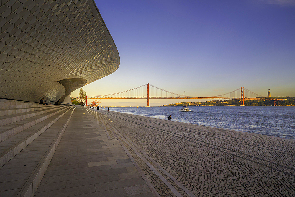 View of MAAT - Museum of Art, Architecture and Technology and 25 April Bridge at sunset Lisbon, Portugal, Europe